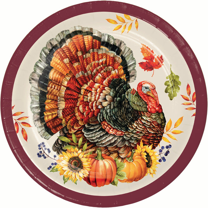 A round paper plate featuring a detailed illustration of a turkey with autumn leaves, pumpkins, sunflowers, and berries, set against a plain white background.
