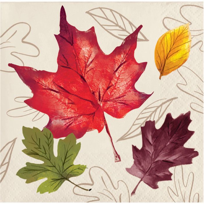 A square napkin featuring watercolor-style autumn leaves on a textured cream background with faint line drawings. The main leaf is a large red maple leaf, with smaller green, yellow, and dark burgundy leaves around it.