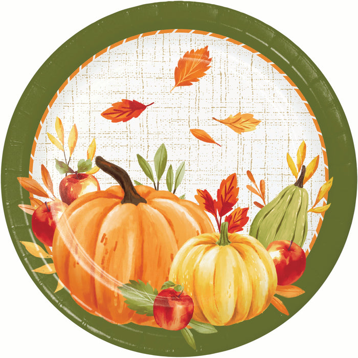 A round paper plate featuring an autumn harvest illustration with pumpkins, apples, a pear, leaves, and a dark olive green border on a white textured background.
