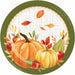 A round paper plate featuring an autumn harvest illustration with pumpkins, apples, a pear, leaves, and a dark olive green border on a white textured background.
