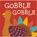 A square napkin featuring the words 'GOBBLE GOBBLE' in large white hand-drawn letters over a red background, with a stylized brown turkey and colorful autumn leaves below.