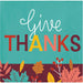 Square napkin with the words 'give THANKS' on a teal background, with autumn leaves and berries along the bottom edge.