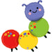 Three colorful segmented foil balloons stacked together form a smiling caterpillar with a purple head, green middle, and red and yellow body segments, each decorated with colored polka dots.