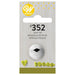 Wilton #352 leaf decorating tip in white metal with a black leaf-shaped opening, displayed on gray wood-grain packaging with yellow accents and bilingual labeling.