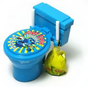 Blue toy toilet with colorful spinning game wheel on the lid, accompanied by a blue storage tank and a yellow sour candy bag.