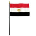 Egyptian flag with red, white, and black horizontal stripes and a gold eagle emblem in the center, mounted on a black stick with a gold spire finial.