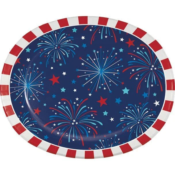 Oval dinner plate with dark blue background featuring red, white, and blue fireworks and stars, bordered by red and white striped edge.