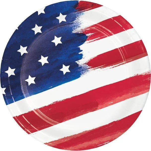Round paper plate with American flag design featuring white stars on blue section and red and white stripes with painterly brushstroke effect.