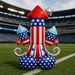 Patriotic foil balloon shaped like a rocket with red pointed top, blue and white striped body with stars, silver swirl fins, and blue balloon feet, displayed on a stadium football field.