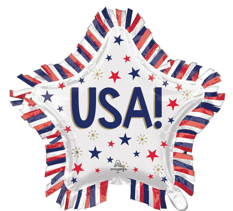 Star-shaped white mylar balloon with "USA!" in large navy and gold letters, decorated with red, navy, and gold stars, surrounded by red, white, and navy striped fringe edges.