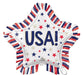 Star-shaped white mylar balloon with "USA!" in large navy and gold letters, decorated with red, navy, and gold stars, surrounded by red, white, and navy striped fringe edges.