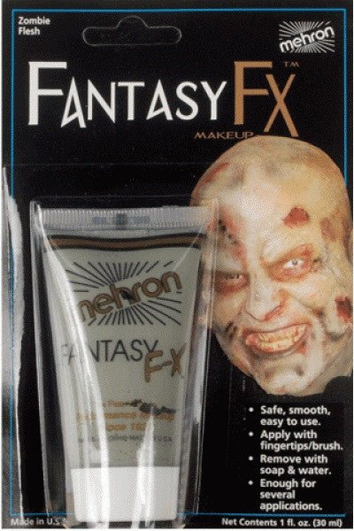 Fantasy FX Makeup cream tube in zombie flesh tone displayed next to a prosthetic zombie face with pale, decayed skin and red sores.