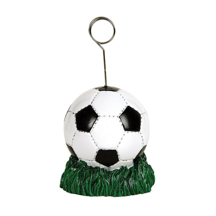 Soccer ball photo holder with black and white paneled design and green grass base, featuring a metal wire loop at top for hanging.