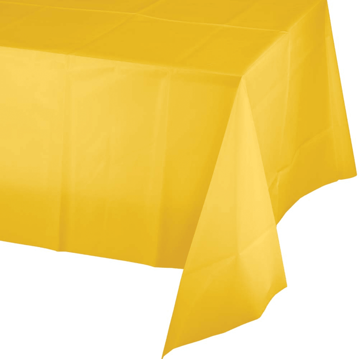 Bright yellow plastic tablecloth draped and folded, showing the material's texture and draping against a white background.