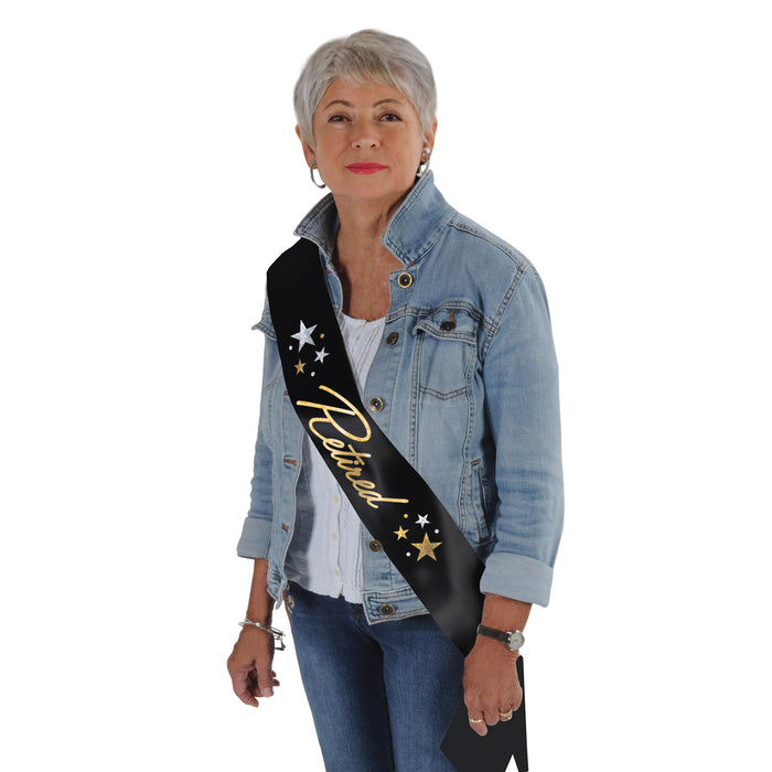 A glittered satin sash worn across the body printed with a retired design. Sold as a single piece.