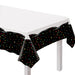 Officially Retired Plastic Table Cover with a white center and black confetti border featuring colorful retirement party accents.