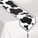 A table runner printed with a cow print design. Sold as a single piece.