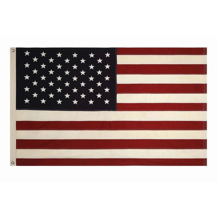 American flag with dark blue canton containing white stars and red and white stripes, displayed horizontally with two metal grommets for hanging.