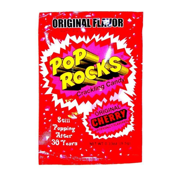 Red Pop Rocks candy package with yellow and pink comic-style burst graphics, labeled "Original Cherry" flavor and "Still Popping After 30 Years," containing 0.33 ounces of crackling candy.