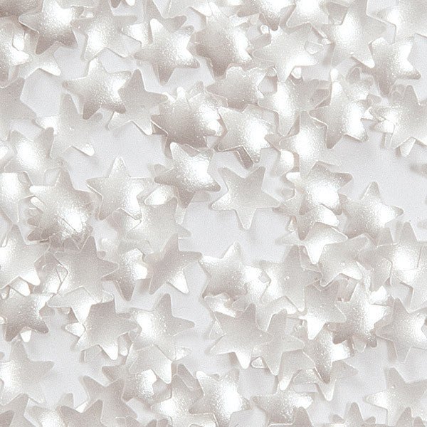 Scattered translucent white and silver star-shaped sprinkles with a sparkling finish on a light background.