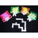 Twelve colorful vinyl cases in pink, green, yellow, and blue containing white plastic dominoes arranged on a black surface.