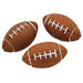 Three brown foam footballs with white stitching arranged on a white background.