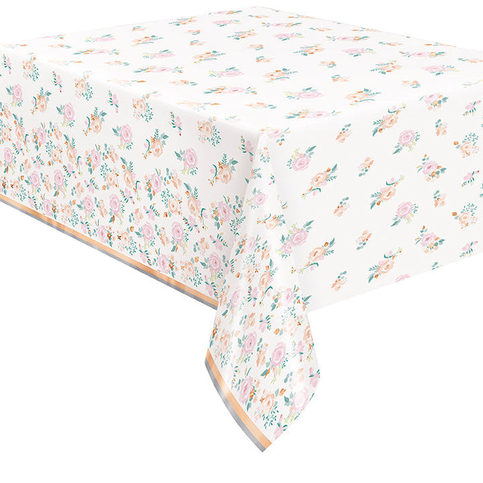 Foil Pink Blooms tablecover with pink, peach, and teal floral patterns on a white background, floral side border, and metallic foil stripe accent.