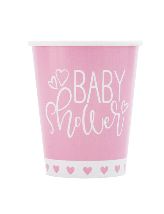 Pink 9-ounce baby shower paper cup with white script lettering, heart accents, and a white border with pink hearts.