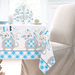 Blue floral elephant baby shower plastic tablecover with gray elephants, blue gingham accents, flowers, and “Baby” lettering on a party table.