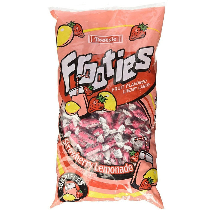 Tootsie Frooties fruit flavored chewy candy bag in coral pink packaging with strawberry and lemon illustrations, containing individually wrapped pink and white candies, labeled Strawberry Lemonade flavor.