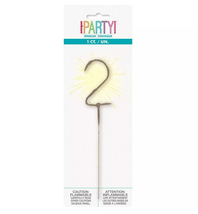 Number 2 shaped sparkler candle with gold radiating spikes on a stick, packaged in a cardboard header card labeled Party Sparkler.