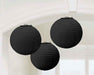 Three black paper lanterns with textured ribbed surfaces and hanging loops suspended against a white ceiling in an interior space.
