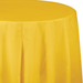 Bright yellow round tablecloth draped over a table, showing the fabric's smooth texture and full coverage with natural folds and shadows.