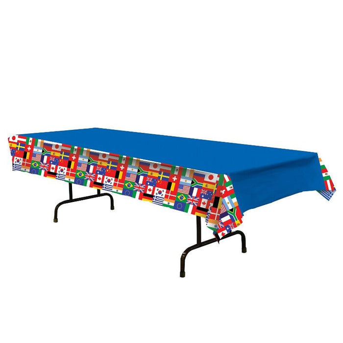 Blue plastic tablecloth with a border strip featuring colorful international flags from countries around the world, displayed on a black folding table.