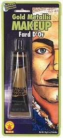 Gold metallic makeup tube with applicator brush displayed on packaging showing a half face demonstration in gold and skin tone.