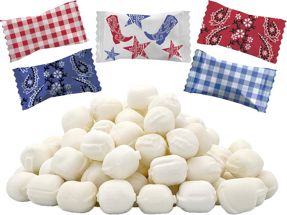 Pile of fifty white oval buttermint candies surrounded by five decorative fabric wraps featuring red gingham, blue gingham, red paisley, blue paisley, and white with red boots and stars patterns.