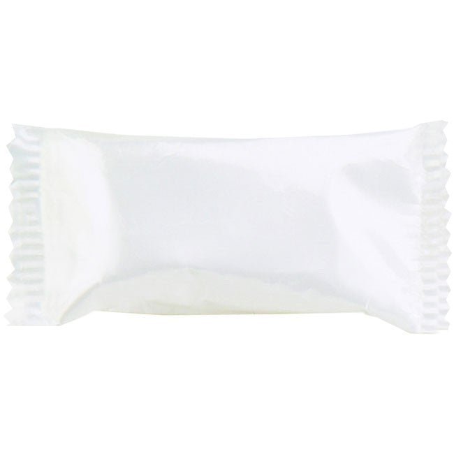 White pillow-shaped candy wrapper with pleated edges containing a cream-colored confection inside.