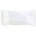 White pillow-shaped candy wrapper with pleated edges containing a cream-colored confection inside.
