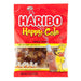 Haribo Happy Cola Gummi Candy: cola-bottle gummies, dark brown in color. Sold in a 5 oz clear plastic peg bag that hangs from a printed header card, with the candy visible inside.