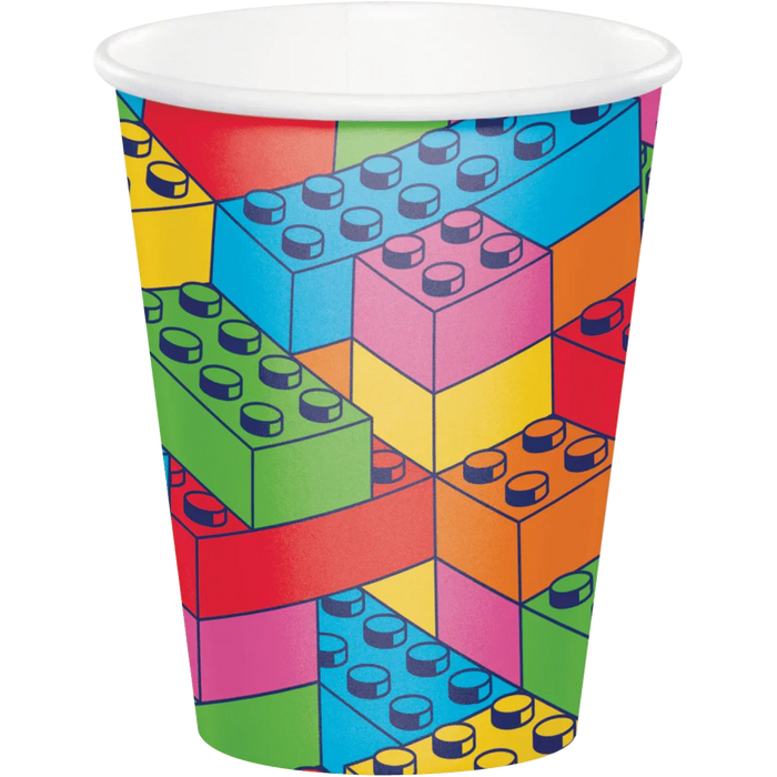 Colorful paper cup featuring a geometric design with interlocking building blocks in red, yellow, green, blue, pink, and orange with studs printed across the surface.