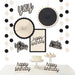 Birthday Chic Birthday Decorating Kit with black and cream paper fans, dot garlands, birthday signs, and tabletop cake decorations.