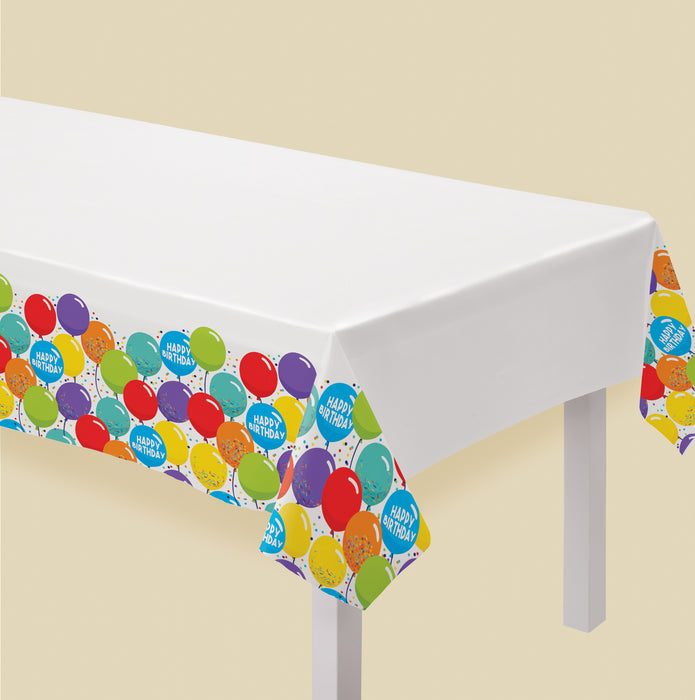 Birthday Celebration Plastic Table Cover with a white center and colorful balloon-print border featuring confetti and Happy Birthday balloon accents.