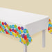 Birthday Celebration Plastic Table Cover with a white center and colorful balloon-print border featuring confetti and Happy Birthday balloon accents.