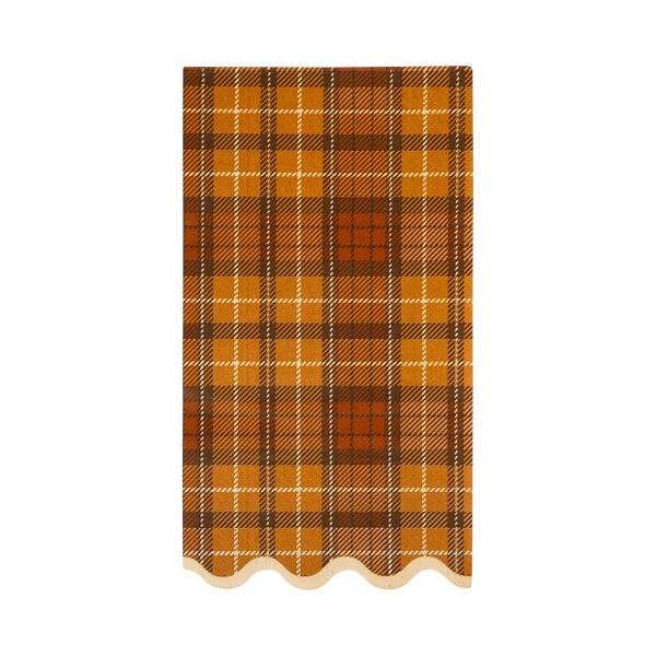 Plaid patterned napkin with a scalloped edge on a white background