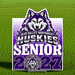 Blue Valley Northwest Huskies Senior 2027 yard sign featuring a purple, black, and white husky mascot design, displayed on green grass with a centered metal H-stake.