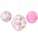 Floral paper lantern set with two round floral print lanterns and one solid pink lantern hanging on white strings.