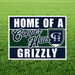 Home of a Copper Hills Grizzly yard sign featuring bold navy and green school colors, large white "HOME OF A" and "GRIZZLY" text, a script-style "Copper Hills" across the center, and the Copper Hills High School shield logo on a corrugated plastic yard sign with an H-stake for outdoor display.