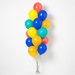 Despicable Me themed accent balloon bouquet with yellow, blue, teal, orange, and coral balloons with curling ribbon.