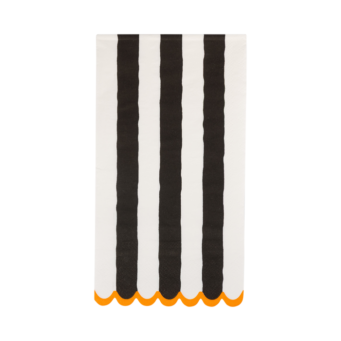 Striped napkin with black and white vertical stripes and orange scalloped edge on a white background