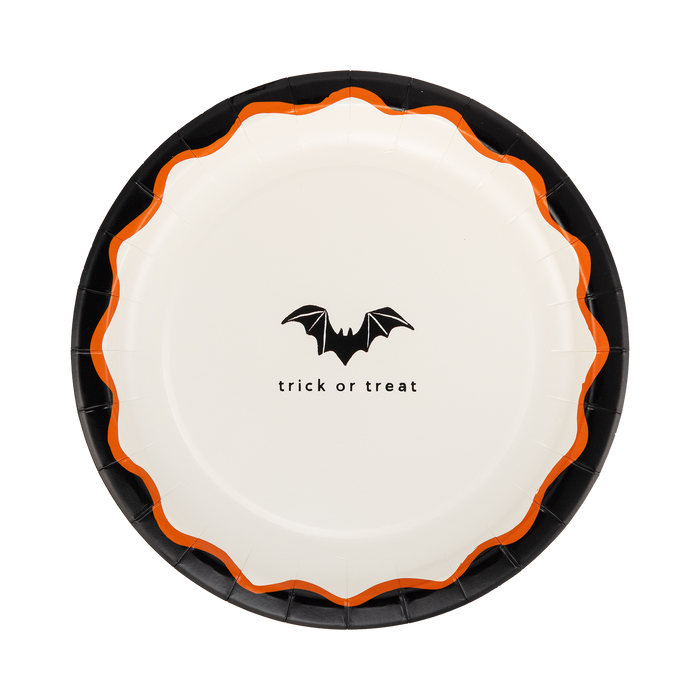 Halloween-themed paper plate with bat design and 'trick or treat' text on a white background